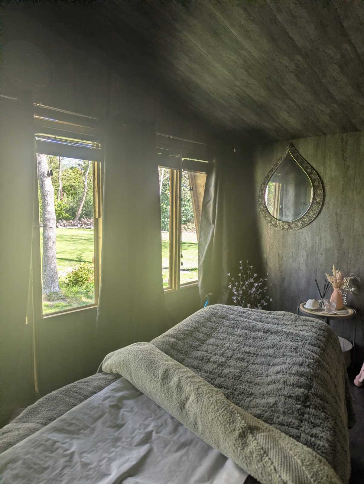 Trees seen through the window of the treatment room at The Tollwood Retreat